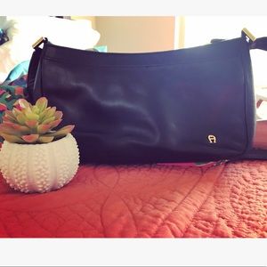 Black baguette leather bag with gold accents